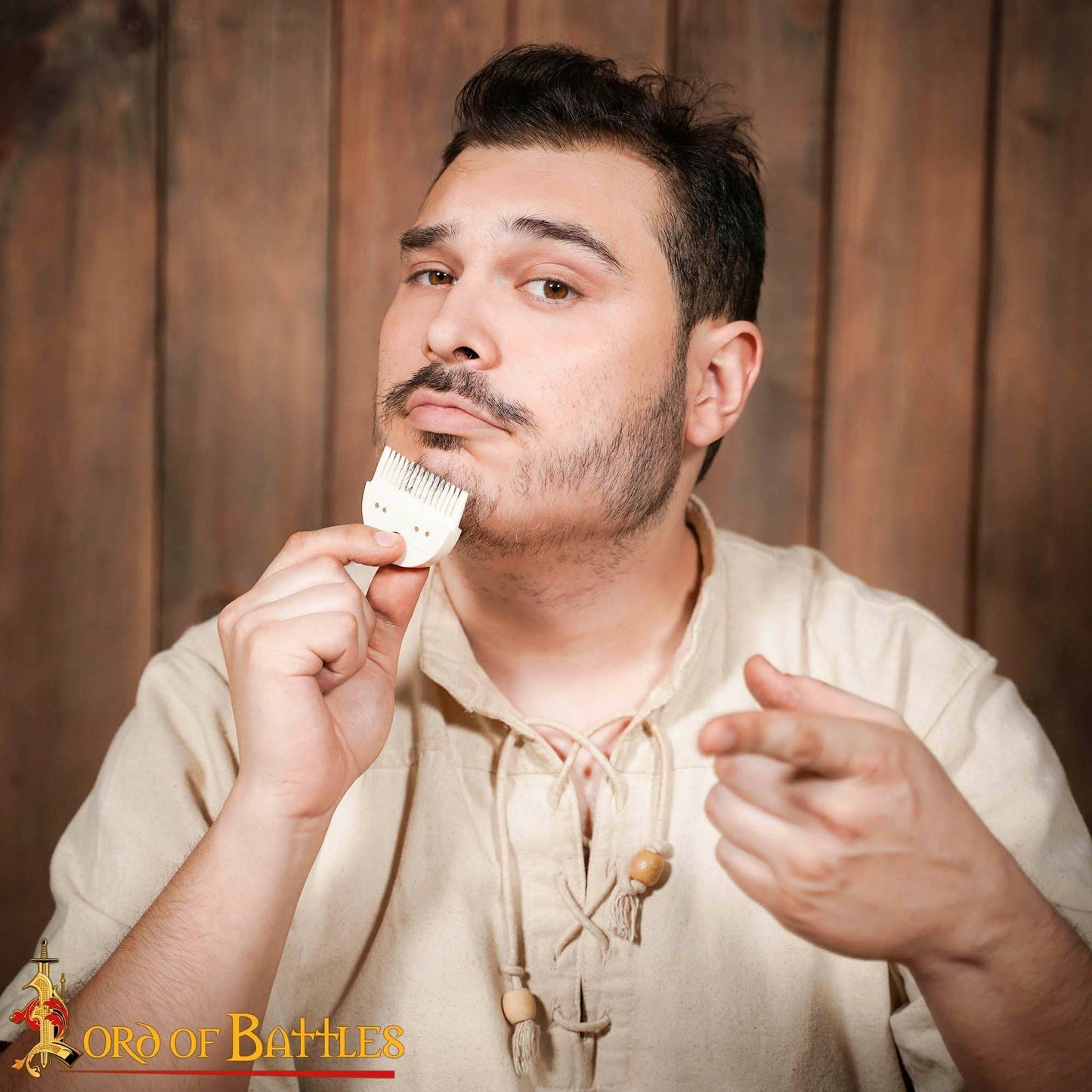 Man using a Germanic bone beard comb for grooming, dressed in medieval attire. A perfect historical replica for reenactors and Viking enthusiasts.
