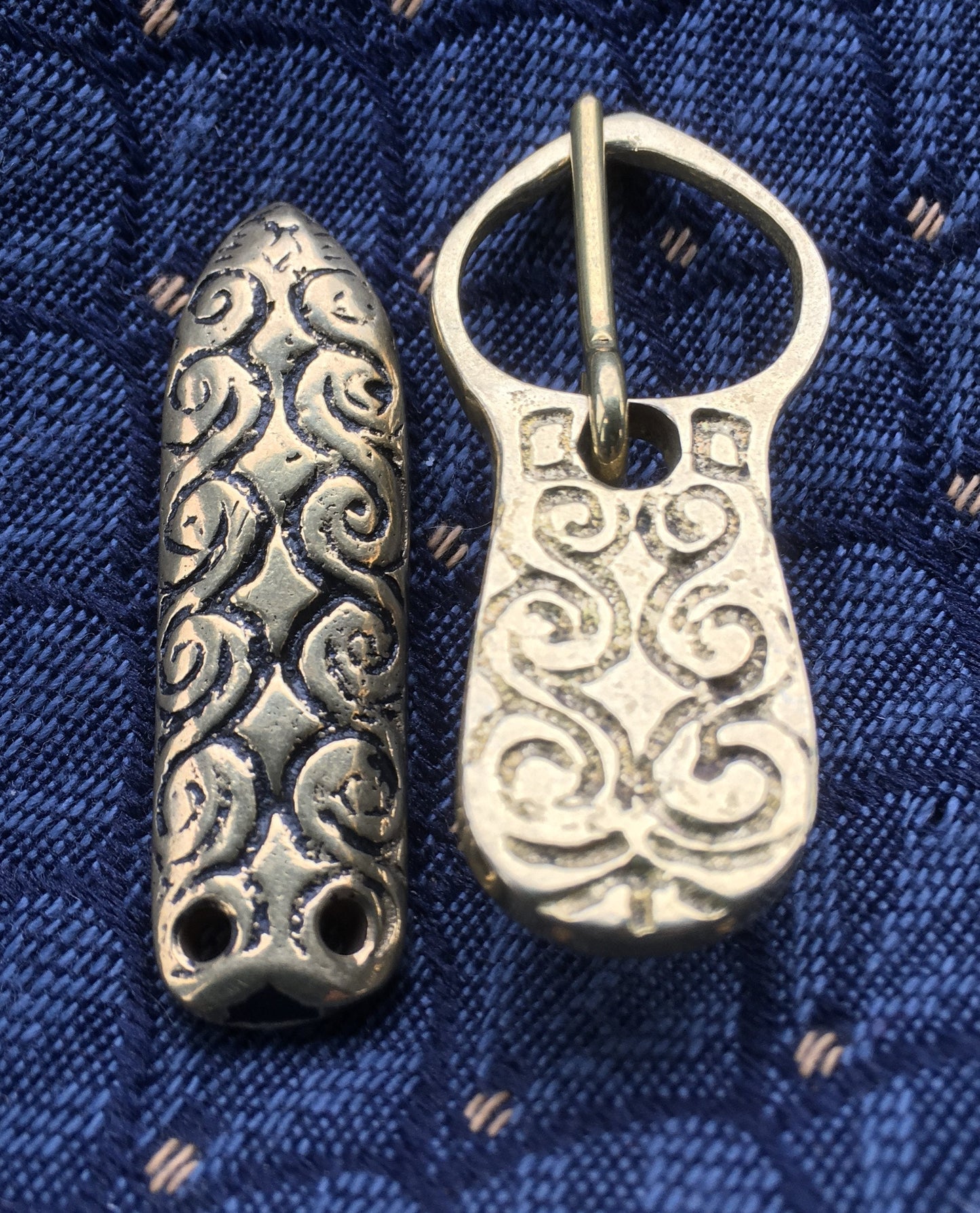 Viking buckle and strap end with a swirling pattern